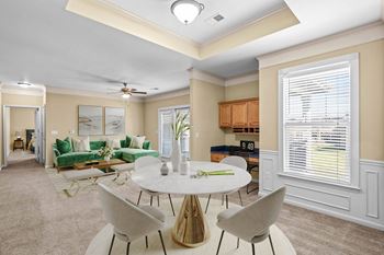 A well-lit dining area with a round table and chairs.
